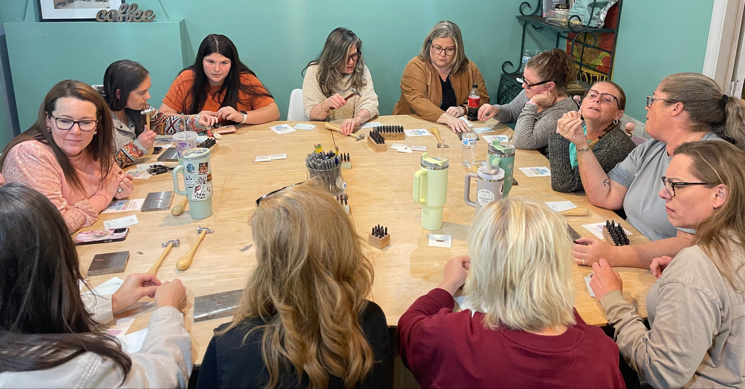 Group of women sitting around a table in a meeting room.
